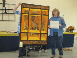 Image of Peoples Choice Winner of a wall quilt image of a fall trees through a window